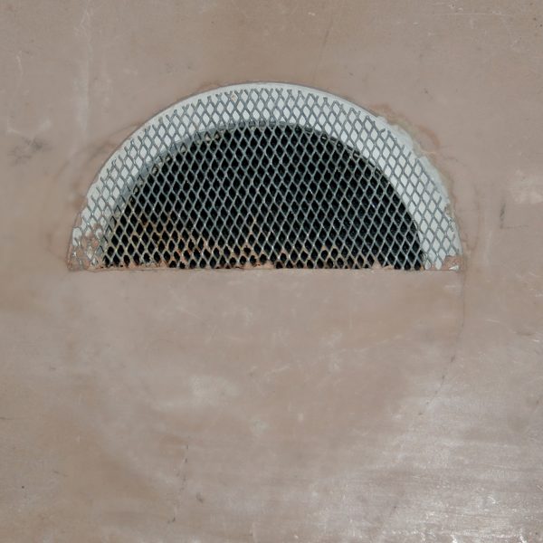 Cable access mesh plate embedded on ceiling and half plastered over