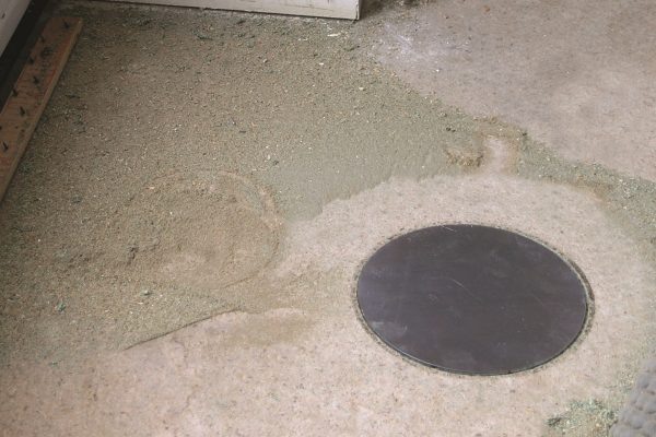 Solid cable access plate installed in a floor