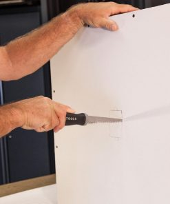 Klein Tools Jab Saw / Pad Saw being used on site - person holding saw about to cut into drywall