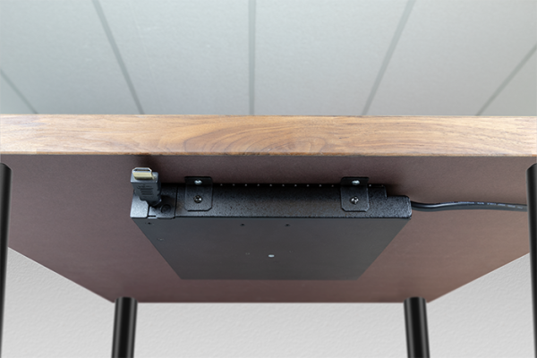 FSR Low Profile Cable retractor mounted on the underside of the table using the FSR Under Table Bracket Mounting kit