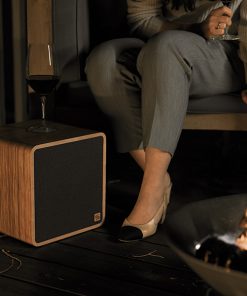 SOWA Sound Wireless Speakers - showing a speaker unit next to someone sitting in a garden area.